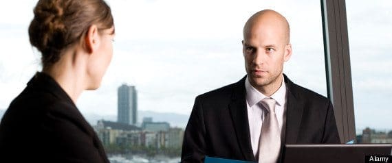 Young woman having a job interview, skeptical boss