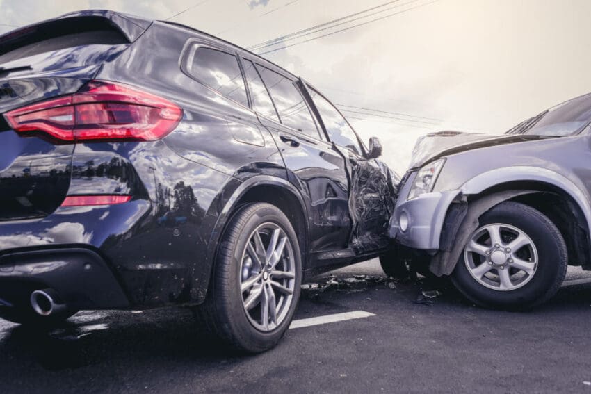 Car crash dangerous accident on the road. SUV car crashing beside another one on the road..