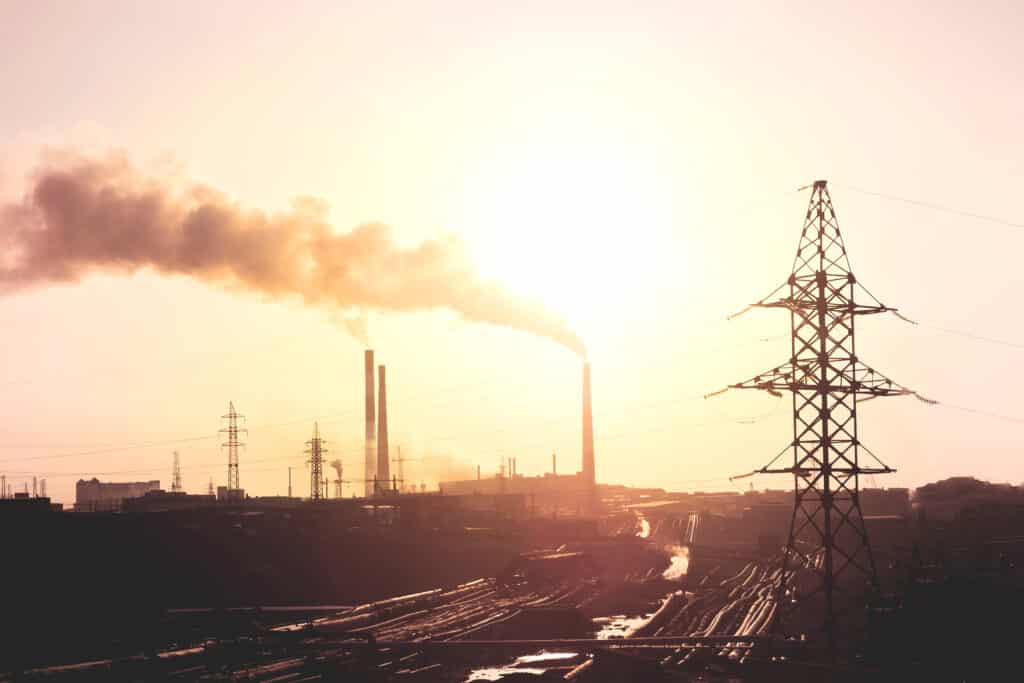 Air,Pollution,Smoke,From,Pipes,And,Factory,With,Sunset,Background