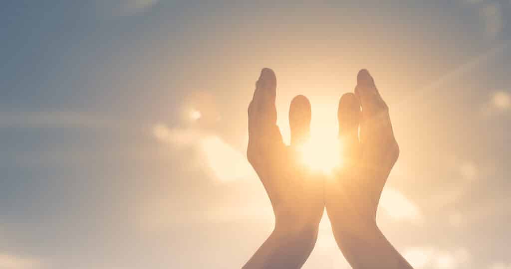 Woman,Hands,Holding,The,Sun,At,Dawn.,Freedom,And,Spirituality