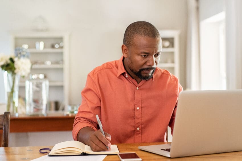 Mature,Man,Working,On,Laptop,While,Taking,Notes.,Businessman,Working