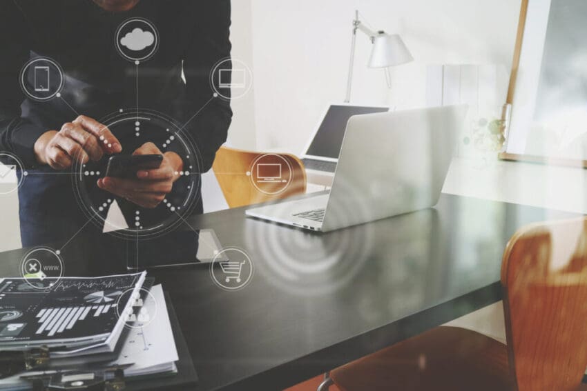 Businessman,Or,Designer,Using,Smart,Phone,With,Laptop,And,Digital