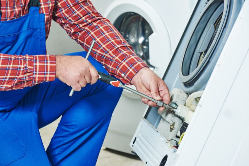 Washing,Machine,Repair.,Repairer,Hands,With,Screwdriver,Disassembling,Damaged,Unit