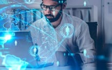 Bearded,Businessman,Using,Laptop,In,Blurry,Office,With,Double,Exposure