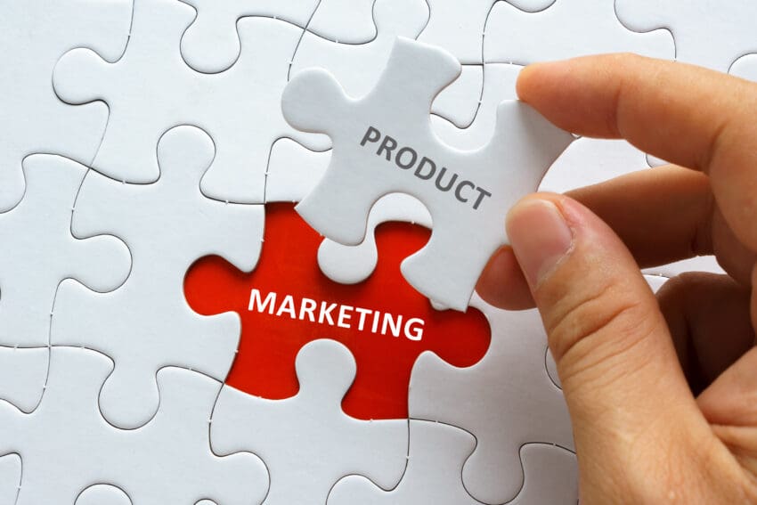 Hand,Holding,Piece,Of,Jigsaw,Puzzle,With,Word,Product,Marketing.