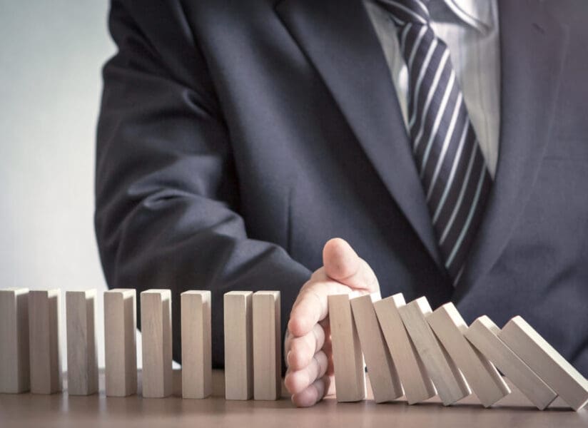 Management,Concept:,Manager,Hand,Stopping,The,Domino,Effect,On,Office