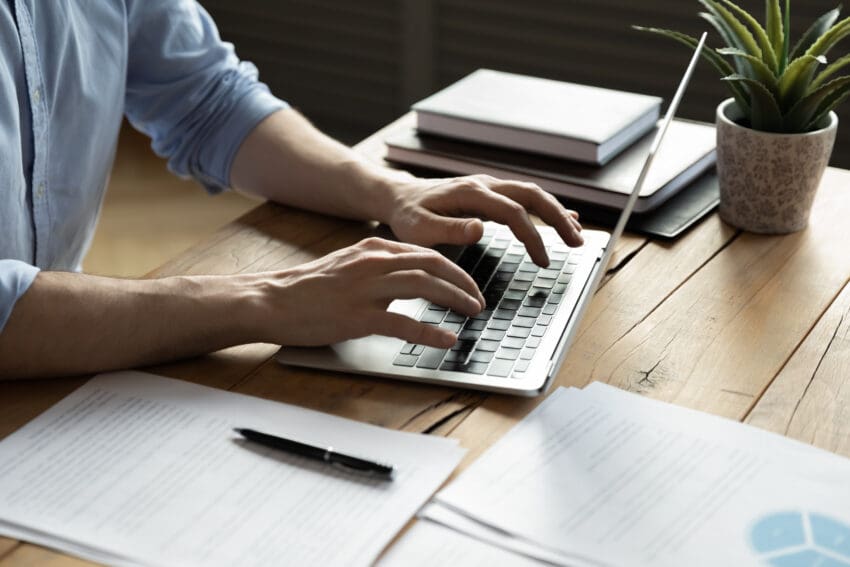 Close,Up,Businessman,Using,Laptop,,Typing,On,Keyboard,,Sitting,At
