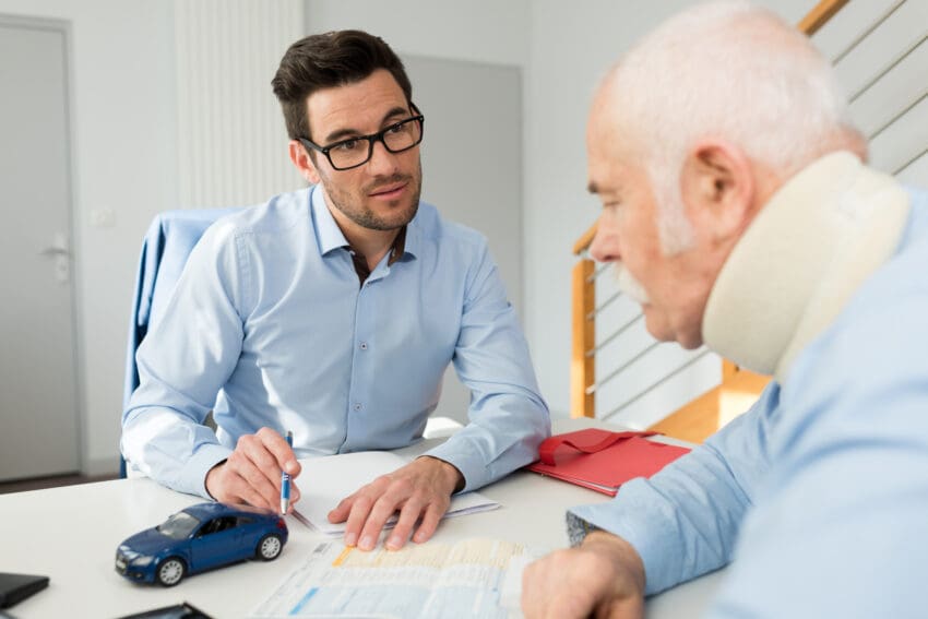 Personal,Injury,Lawyer,In,Meeting,With,Client,Wearing,Neck,Brace